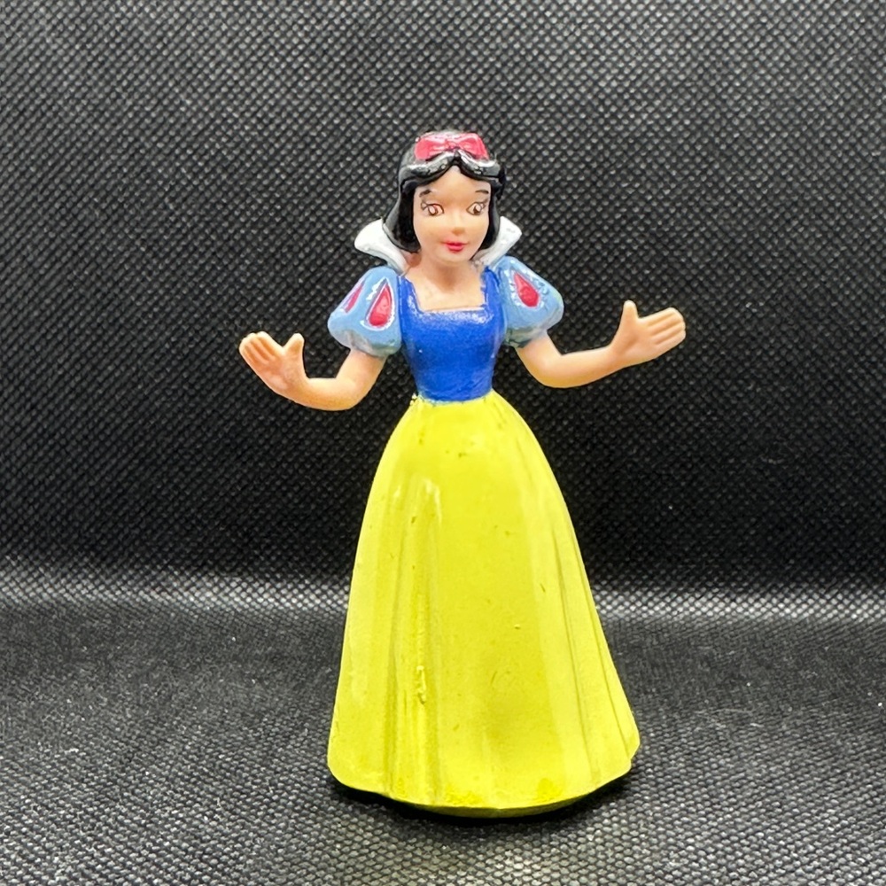Snow White and six of the Seven Dwarfs, figurines.